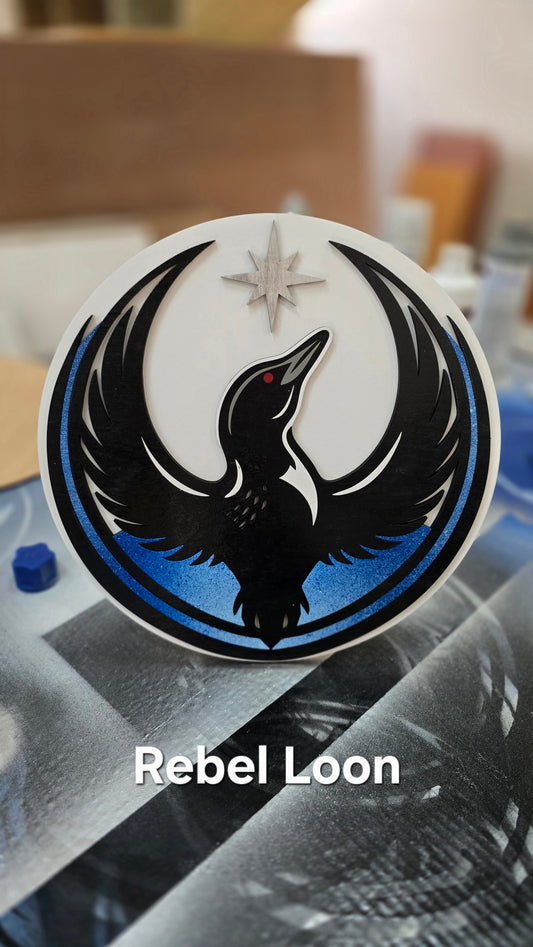 Round Rebel Loon wood sign with a black loon silhouette on white, handmade in Minnesota