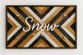 Decorative wall art with 'Snow est. 2021' text on a geometric patterned background